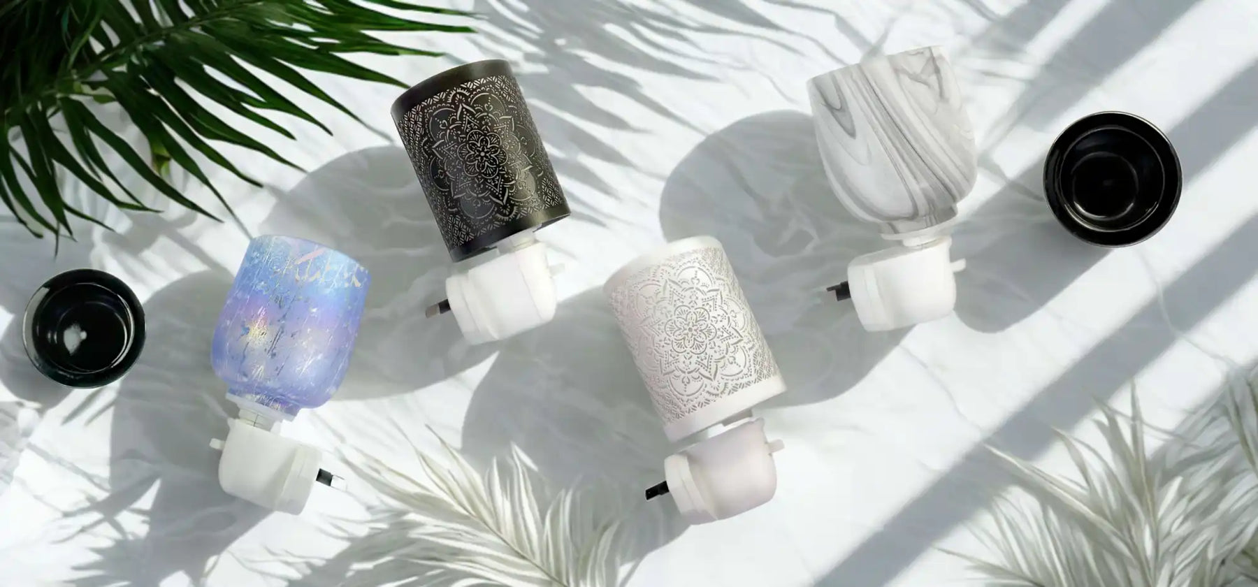 A collection of plug-in air fresheners with decorative covers.