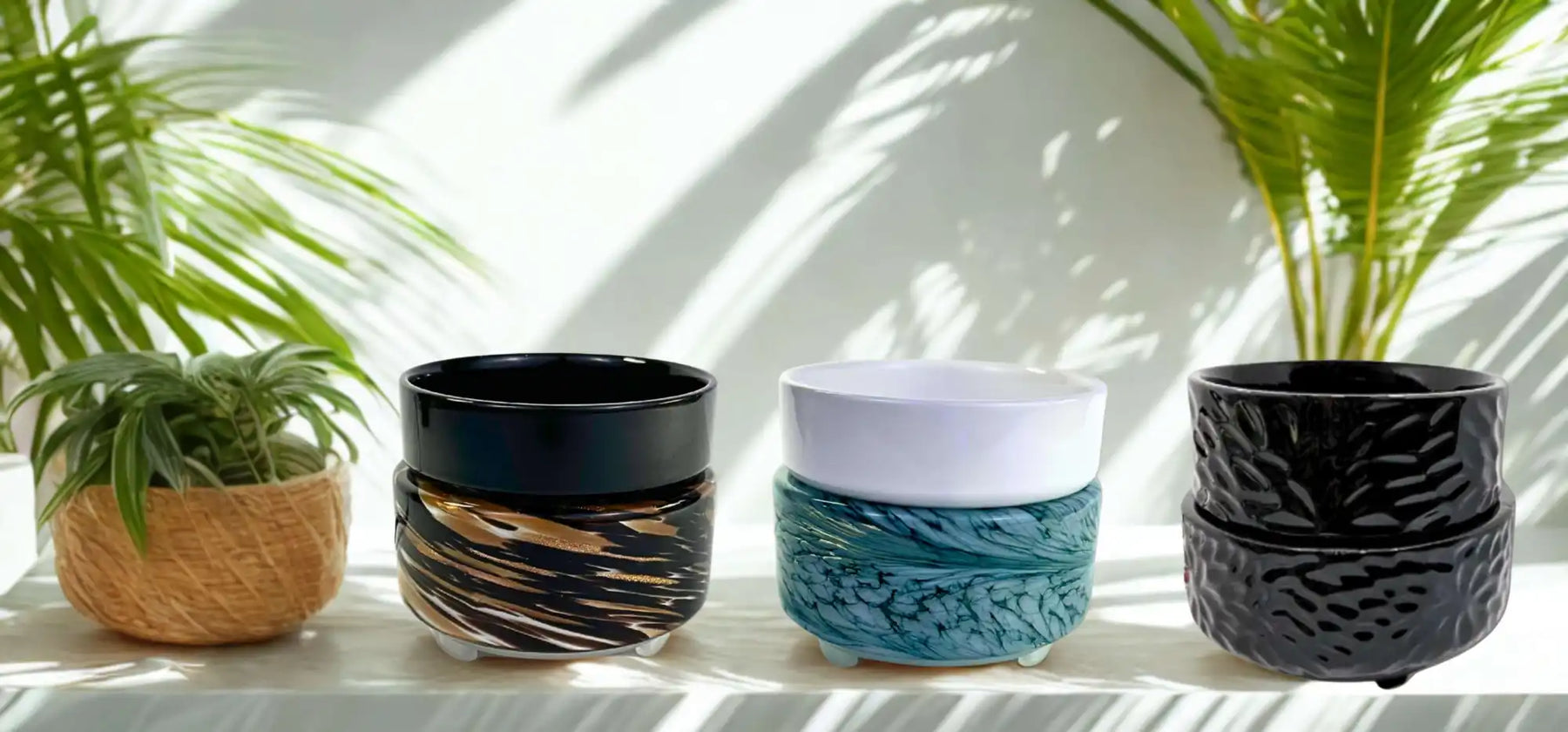 Four decorative plant pots with varied designs.