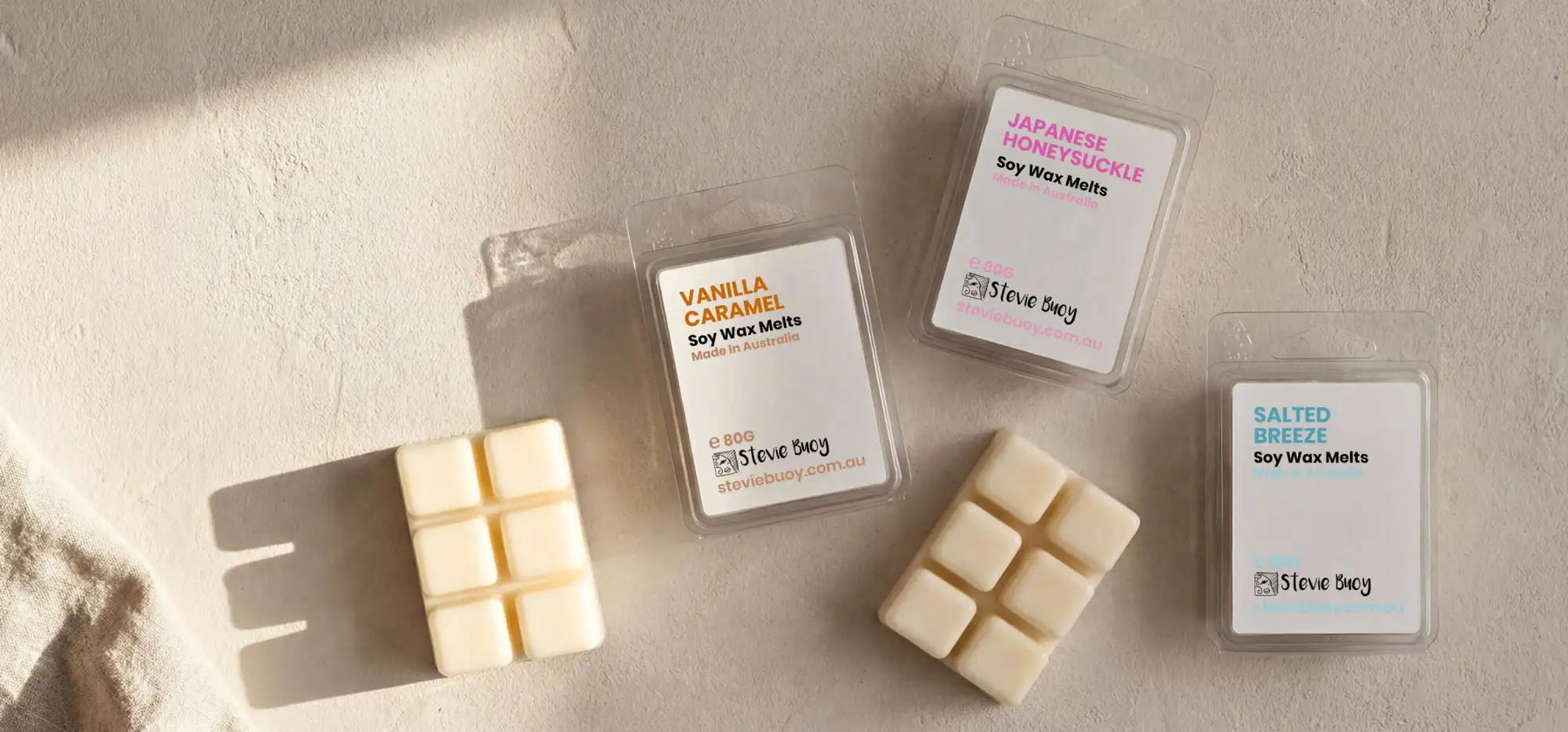 White soy wax melts in clear plastic packaging with colorful labels from steve sacy.
