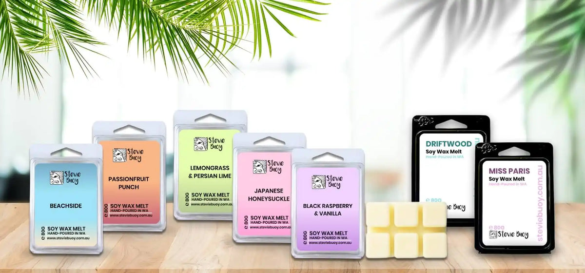 Assorted scented soy wax melts in clear and black packaging.