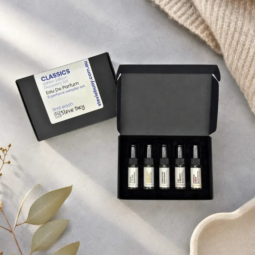 Black rectangular box containing five 3ml perfume sampler vials from stevie bucy’s classics winter edition discovery set.