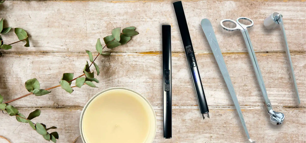 Candle care kit with a jar candle and eucalyptus branch.