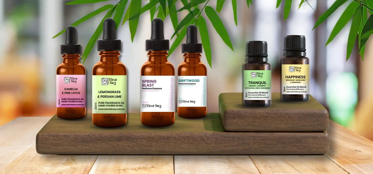 A collection of amber glass dropper bottles and smaller essential oil bottles with various colored labels.