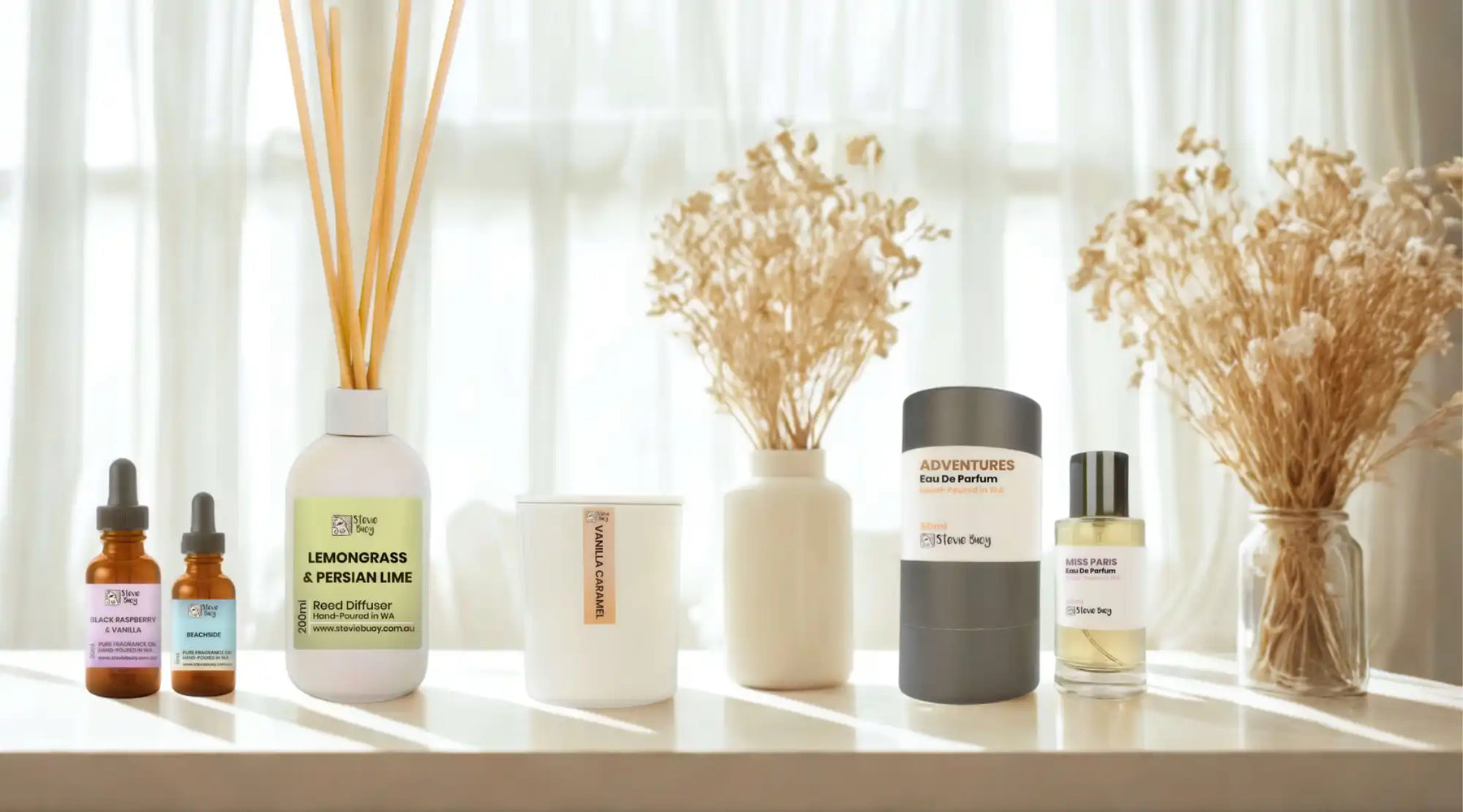 A collection of home fragrance products including reed diffusers, essential oils, candles, and perfumes.