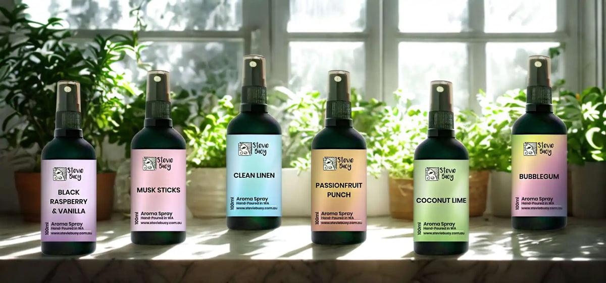 A set of six dark green spray bottles containing various scented air fresheners.