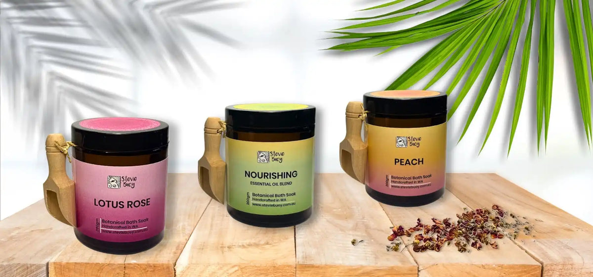 Three jars of bath salts with wooden scoops.