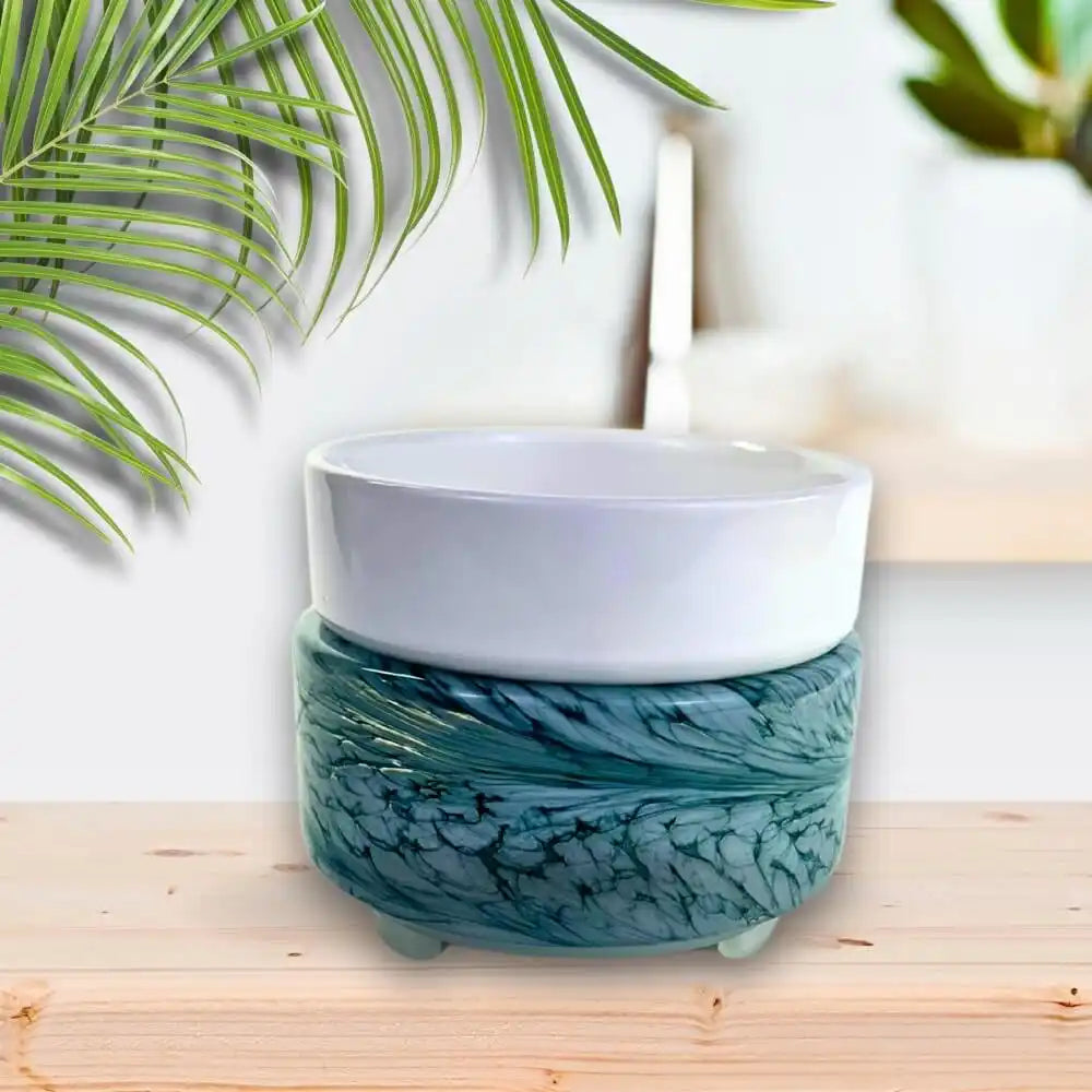 Two-tiered teal and white ceramic warmer.